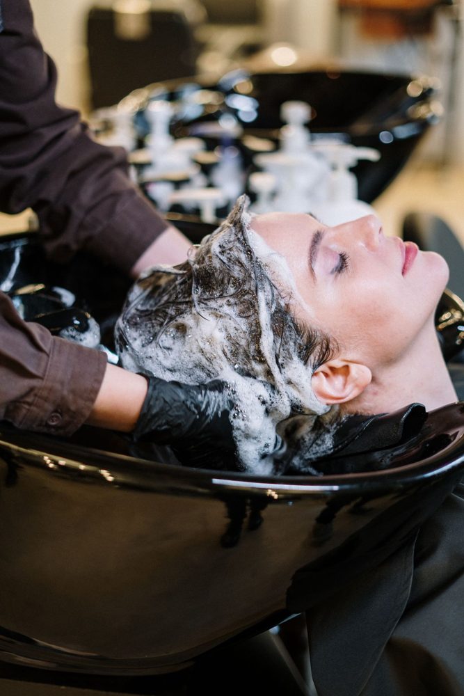 Hair being washed at a backwash basin